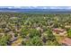 Established neighborhood featuring mature trees and a tranquil view of a nearby lake at 1 Lindenwood Dr, Littleton, CO 80120