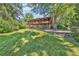 Large backyard featuring a multi-story home with balconies at 1 Lindenwood Dr, Littleton, CO 80120