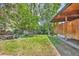 Lush backyard with mature trees, well-manicured lawn and private patio area; ideal for relaxation at 1 Lindenwood Dr, Littleton, CO 80120