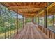Expansive balcony with wood flooring, railing, and natural wood beam ceiling at 1 Lindenwood Dr, Littleton, CO 80120