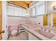 Vintage bathroom with pink tiling, toilet, sink and a countertop at 1 Lindenwood Dr, Littleton, CO 80120
