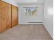 Bedroom with light carpet, light walls and a window at 1 Lindenwood Dr, Littleton, CO 80120