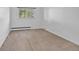 Minimalist bedroom with light carpet, a window and light walls at 1 Lindenwood Dr, Littleton, CO 80120