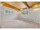 Bedroom with wood beam ceilings and multiple windows providing natural light and scenic outdoor views at 1 Lindenwood Dr, Littleton, CO 80120