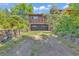Two-car garage with stone walls and landscaping at 1 Lindenwood Dr, Littleton, CO 80120