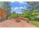Charming stone patio with built-in fire pit, perfect for outdoor gatherings and enjoying the peaceful surroundings at 1 Lindenwood Dr, Littleton, CO 80120