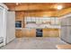 Retro kitchen with stainless steel appliances and wood cabinets at 1 Lindenwood Dr, Littleton, CO 80120