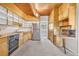 Retro kitchen featuring wood cabinets, stainless steel appliances and concrete flooring at 1 Lindenwood Dr, Littleton, CO 80120
