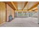 Spacious living room with exposed wood beam ceiling, brick fireplace, and large windows overlooking the backyard at 1 Lindenwood Dr, Littleton, CO 80120