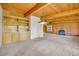 Bright living room with wood beam ceilings, built-in storage, fireplace, and large windows at 1 Lindenwood Dr, Littleton, CO 80120