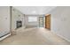 Bright living room with fireplace, large window and door with backyard access at 1 Lindenwood Dr, Littleton, CO 80120