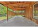Spacious covered patio featuring wood finishes and a concrete floor, perfect for outdoor entertaining at 1 Lindenwood Dr, Littleton, CO 80120