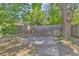 Secluded patio area with stone and brick accents, offering a private outdoor space with mature trees at 1 Lindenwood Dr, Littleton, CO 80120
