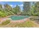 Inviting in-ground swimming pool with brick surround and mature trees offering a private backyard oasis at 1 Lindenwood Dr, Littleton, CO 80120