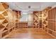 Basement wine cellar featuring custom wood racking and hardwood floors at 1 Lindenwood Dr, Littleton, CO 80120