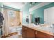 Cozy bathroom featuring a tiled shower, bathtub, and vanity with plenty of counter space at 8029 E 23Rd Ave, Denver, CO 80238