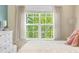 Bright bedroom featuring soft lighting, window, and plush bedding, creating a peaceful ambiance at 8029 E 23Rd Ave, Denver, CO 80238