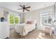 Cozy bedroom with a large window, plush carpet, and a charming vanity area for a relaxing retreat at 8029 E 23Rd Ave, Denver, CO 80238
