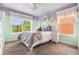 Charming bedroom with whimsical butterfly decor, bright accent wall, and inviting plush bedding at 8029 E 23Rd Ave, Denver, CO 80238