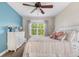 Comfortable bedroom with an accent wall, large window, and plush bedding for a cozy retreat at 8029 E 23Rd Ave, Denver, CO 80238