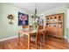 Traditional dining room featuring wooden table, chandelier, and hutch with natural light at 8029 E 23Rd Ave, Denver, CO 80238