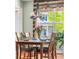 A cozy dining room featuring a wooden table, chandelier, and large window providing natural light at 8029 E 23Rd Ave, Denver, CO 80238