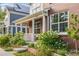 Inviting two-story home with a covered porch, brick columns, and lush landscaping enhancing its appeal at 8029 E 23Rd Ave, Denver, CO 80238