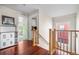 Hallway entrance with wood floors, and view of the bedroom with ample natural light streaming in through the windows at 8029 E 23Rd Ave, Denver, CO 80238