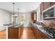 Spacious kitchen with cherry wood cabinets, stainless appliances and granite countertops at 8029 E 23Rd Ave, Denver, CO 80238