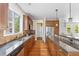 Well-equipped kitchen featuring wooden cabinets, granite countertops, stainless steel appliances, and hardwood floors at 8029 E 23Rd Ave, Denver, CO 80238