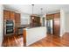 Well-lit kitchen featuring stainless steel appliances and an island with granite countertop at 8029 E 23Rd Ave, Denver, CO 80238