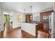 Bright kitchen boasting cherry wood cabinetry and an island with granite countertops at 8029 E 23Rd Ave, Denver, CO 80238
