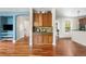 Open-concept living room with hardwood floors and wood cabinetry at 8029 E 23Rd Ave, Denver, CO 80238