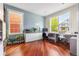 Bright office featuring hardwood floors, modern cabinets, a sleek desk and views from two large windows at 8029 E 23Rd Ave, Denver, CO 80238