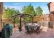 Inviting outdoor patio with stone flooring, a pergola, dining set, and lush landscaping create a serene retreat at 8029 E 23Rd Ave, Denver, CO 80238