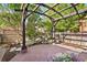 Charming patio featuring a pergola, stone flooring, and a tranquil rock garden with a small waterfall at 8029 E 23Rd Ave, Denver, CO 80238
