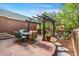 Outdoor patio with a pergola, dining set, stone flooring, and a water feature creates an inviting outdoor living space at 8029 E 23Rd Ave, Denver, CO 80238