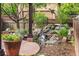 Stone water feature complemented by potted plants and surrounding greenery add a serene ambiance to the yard at 8029 E 23Rd Ave, Denver, CO 80238