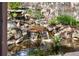 A beautiful water feature with small waterfalls cascading over rocks into a pond, surrounded by lush greenery at 8029 E 23Rd Ave, Denver, CO 80238