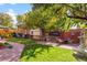 Inviting backyard featuring a dining set, a water fountain, and a beautifully landscaped lawn at 1930 E 8Th Ave, Denver, CO 80206