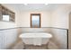 Elegant bathroom with a freestanding tub and white and black tiled walls at 1930 E 8Th Ave, Denver, CO 80206