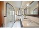 Updated bathroom with glass enclosed shower, double sinks and stylish black and white tile at 1930 E 8Th Ave, Denver, CO 80206