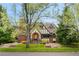 Charming Tudor-style home with a well-manicured lawn and mature trees at 1930 E 8Th Ave, Denver, CO 80206