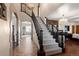 Grand foyer featuring a staircase with dark wood trim, high ceilings, and a decorative chandelier at 1930 E 8Th Ave, Denver, CO 80206