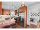 Well-lit kitchen featuring dark wood cabinets, stainless steel appliances, and a breakfast bar area at 1930 E 8Th Ave, Denver, CO 80206