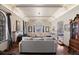 Elegant living room with hardwood floors, beamed ceiling, fireplace and a large arch top window at 1930 E 8Th Ave, Denver, CO 80206