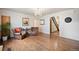 Charming living room featuring hardwood floors, two leather chairs, and elegant chandelier lighting at 1930 E 8Th Ave, Denver, CO 80206