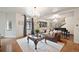 Elegant living room featuring hardwood floors, chandelier, and a comfortable leather sofa at 1930 E 8Th Ave, Denver, CO 80206