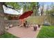 Outdoor patio area with dining furniture, mature trees, and a water fountain feature at 1930 E 8Th Ave, Denver, CO 80206