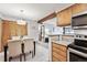 Cozy dining area with wood beam and bar, connecting seamlessly to the kitchen for easy entertaining at 203 Wright St # 102, Lakewood, CO 80228
